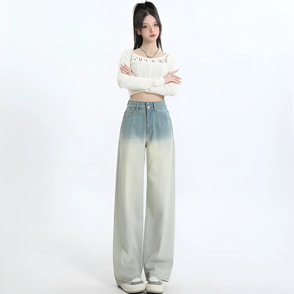 Women's gradient blue wide-leg denim trousers on a neutral background.