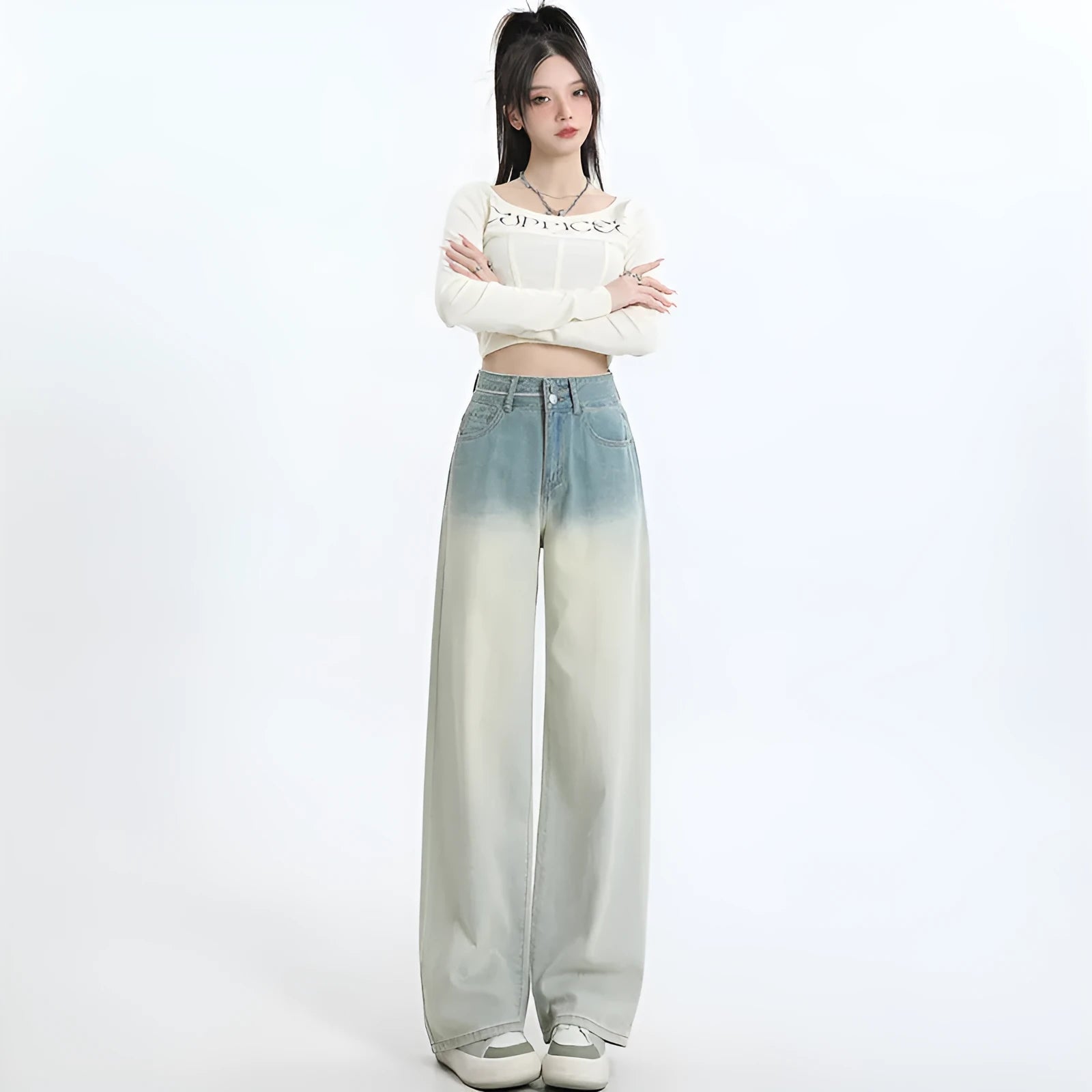 Women's gradient blue wide-leg denim trousers on a neutral background.