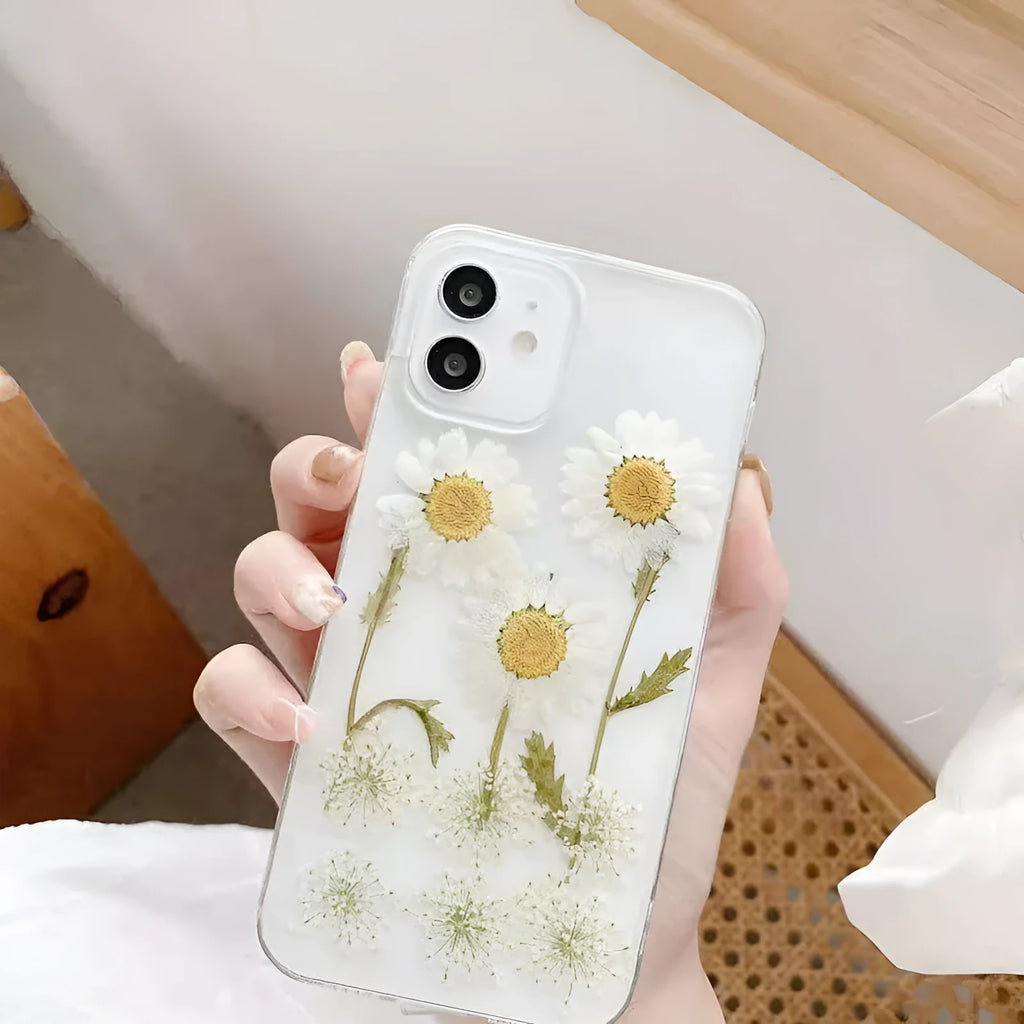 White epoxy daisy floral design on a clear TPU protective case for iPhone models.