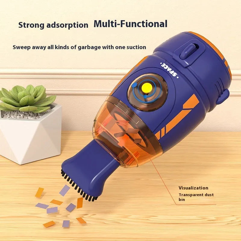 Blue handheld USB desktop vacuum cleaner on a wooden desk next to a keyboard