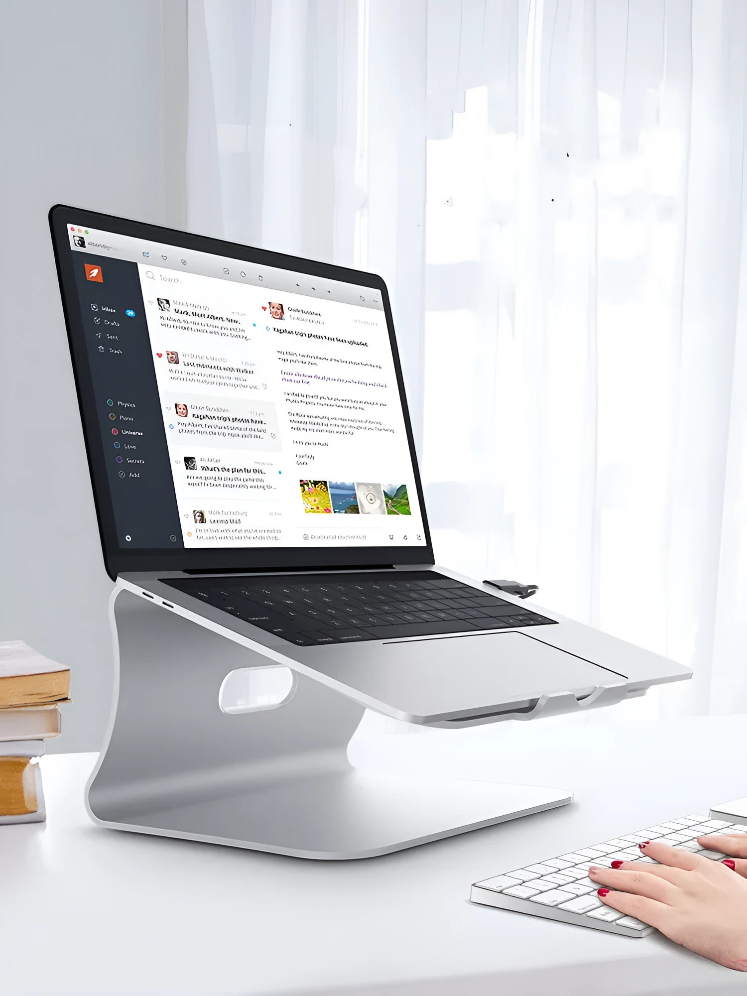 Aluminium laptop cooling stand in grey with rotary hinge for angle adjustment on a wooden desk