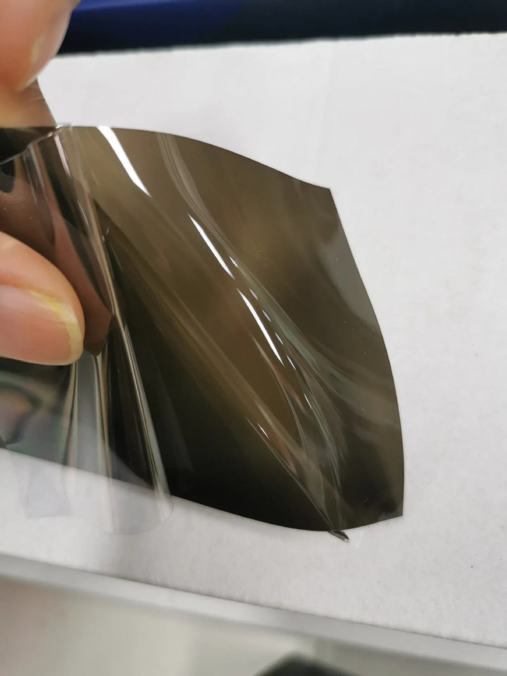 A roll of 30cm wide dark grey car lamp protective film for headlight and taillight protection.