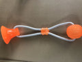 Pet dog rubber sucker molar toy in red colour on smooth surface