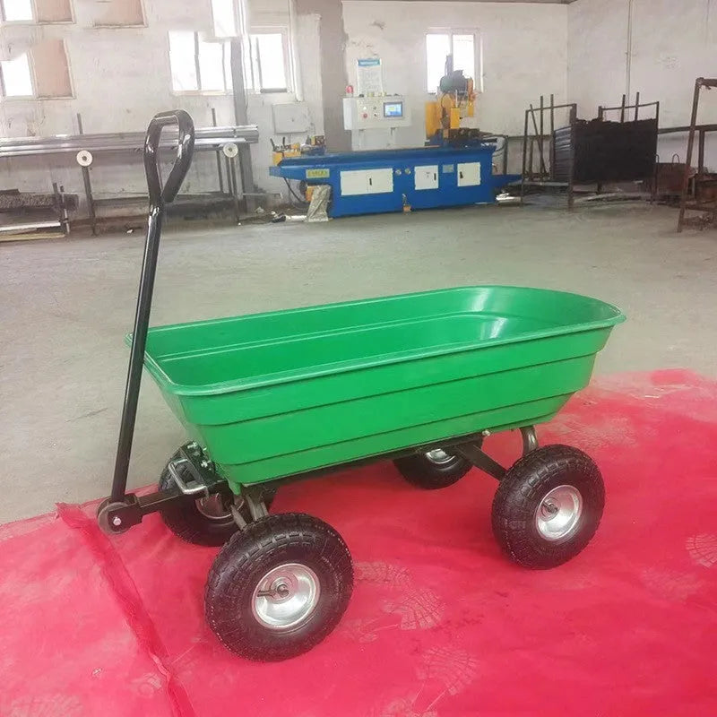 Green four-wheel plastic dump truck with a large cargo bed, shown on grass.