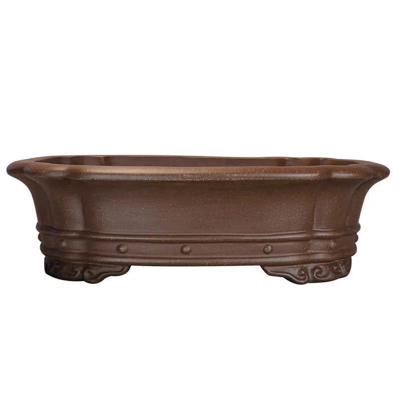 Handmade antique purple sand rectangular begonia flower pot on a desktop.
