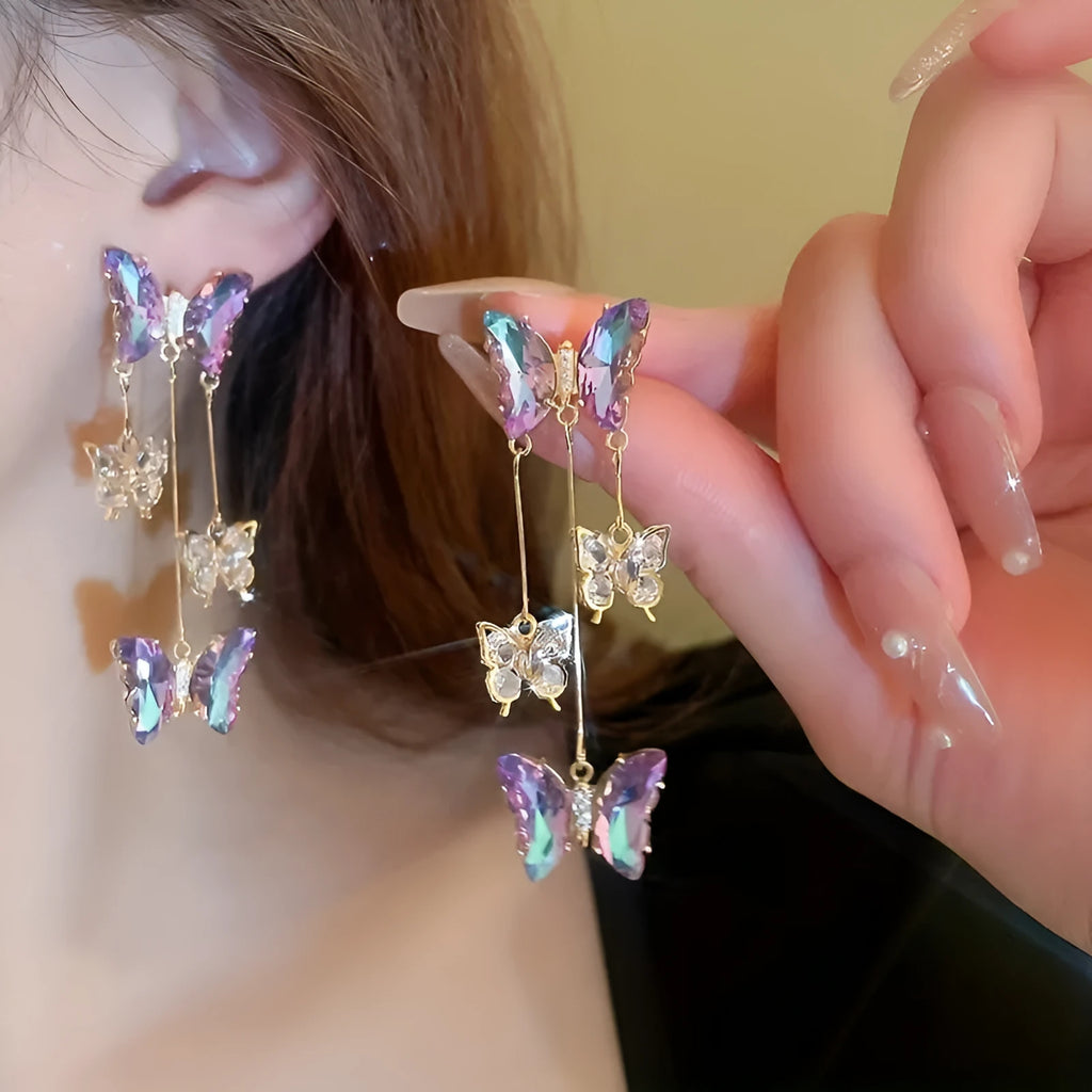 A pair of silver needle-blue purple butterfly tassel earrings with crystal flowers on a 4.5cm drop.