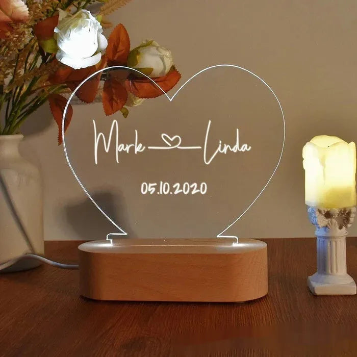Custom transparent acrylic LED night light personalised with names and date, 20cm by 11.5cm.