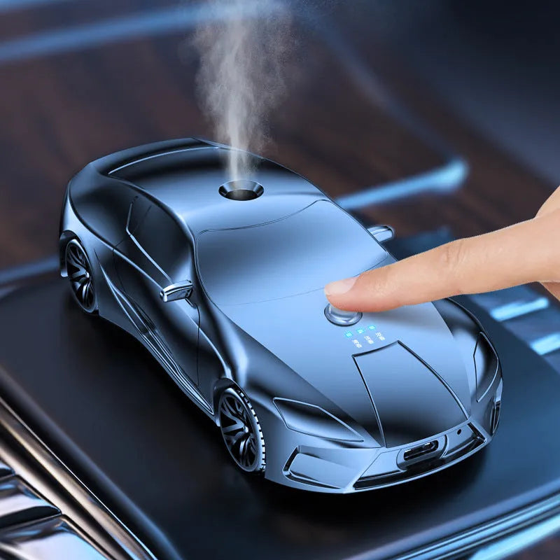 Grey cartoon car model aromatherapy diffuser in aluminium alloy, 12.9 cm x 5.9 cm x 3.7 cm, with three essential oil bottles.