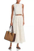 White women's sleeveless top and long skirt set with embroidery detail, laid flat.
