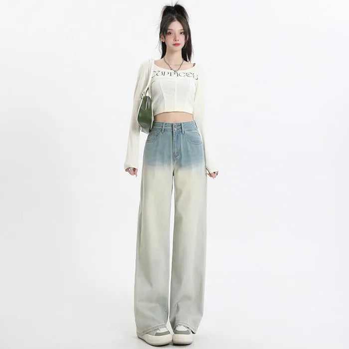Women's gradient blue wide-leg denim trousers on a neutral background.