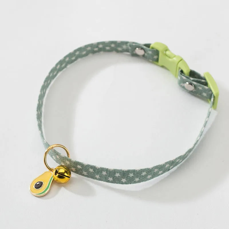 Adjustable green cat collar with a metal bell pendant and a matching bow tie decoration.