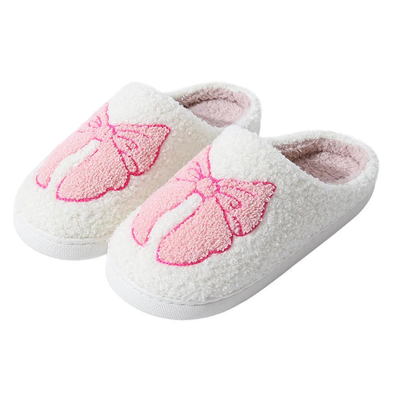 Pink and blue cotton suede slippers with a cartoon bow knot design and TPR sole.