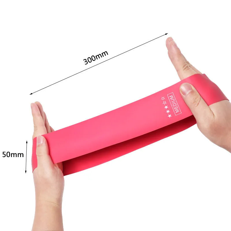 Five pink gradient latex yoga tension bands laid flat showing increasing resistance levels from light pink to rose red