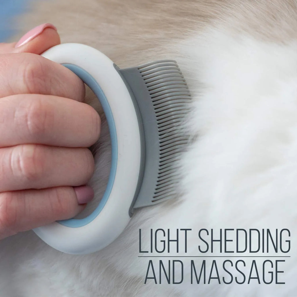 Blue plastic pet grooming comb for removing loose hair from cats and dogs on a white background.