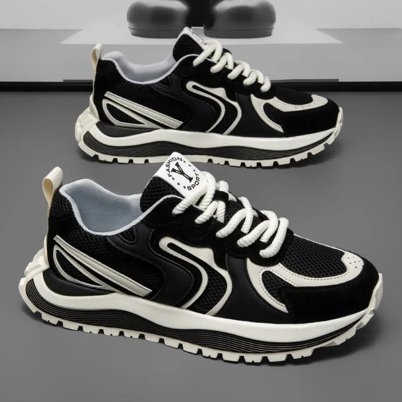 Men's casual sneaker in synthetic leather and mesh, showing round toe and lace-up front.