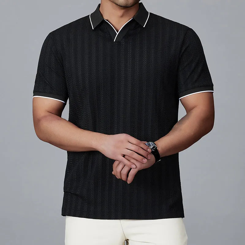 Man wearing a black loose-fit short-sleeved nylon polo shirt on a casual background.