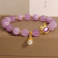 Mauve jade hare head pendant on a clear crystal bracelet, Mori style design.