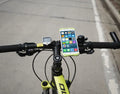Adjustable silicone bicycle phone holder mounted on handlebar with smartphone secured