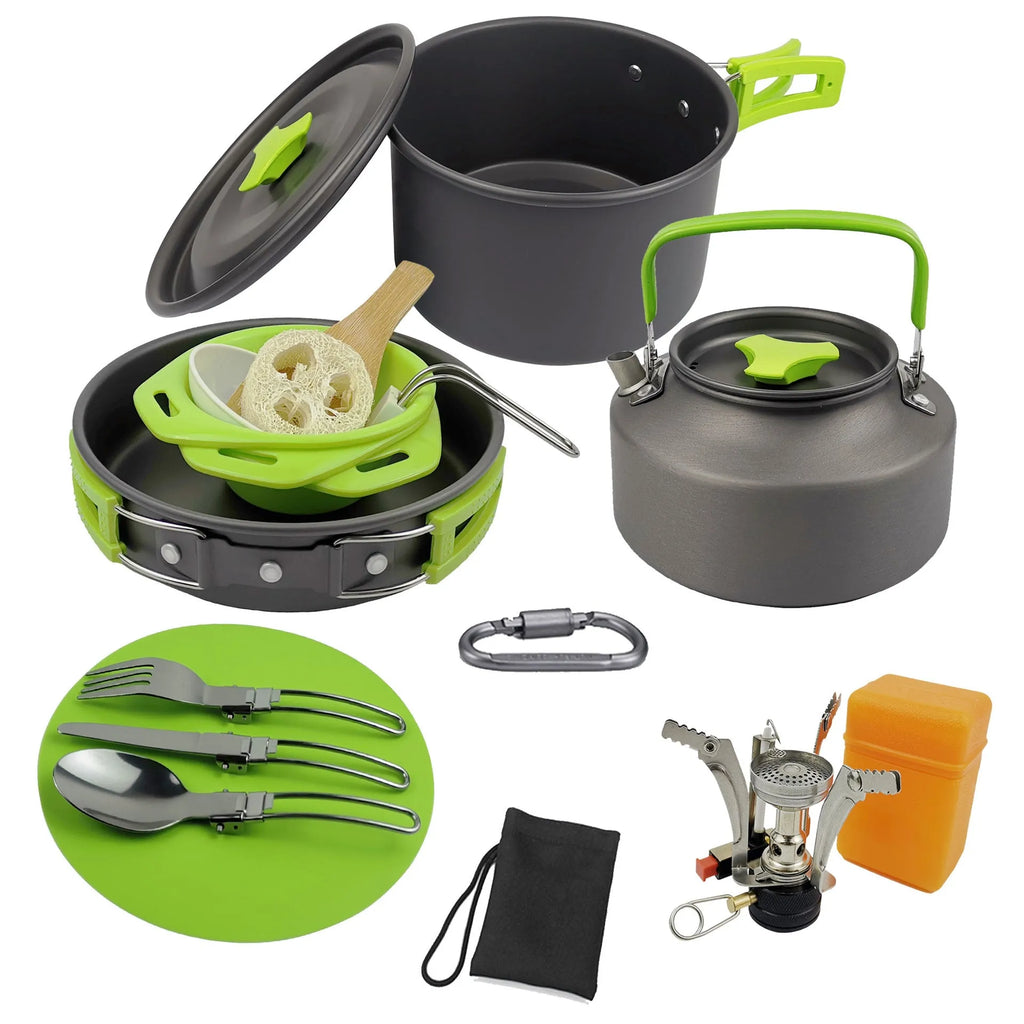 Green aluminium alloy camping teapot set with kettle, frying pan, and pot arranged on a picnic table