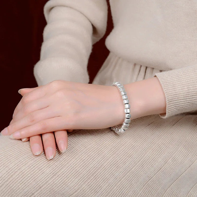 Women's handmade silver bracelet with irregular square design and elastic band