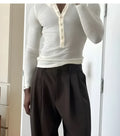 Men's cream apricot coloured ribbed long sleeve henley top with a three-button placket.