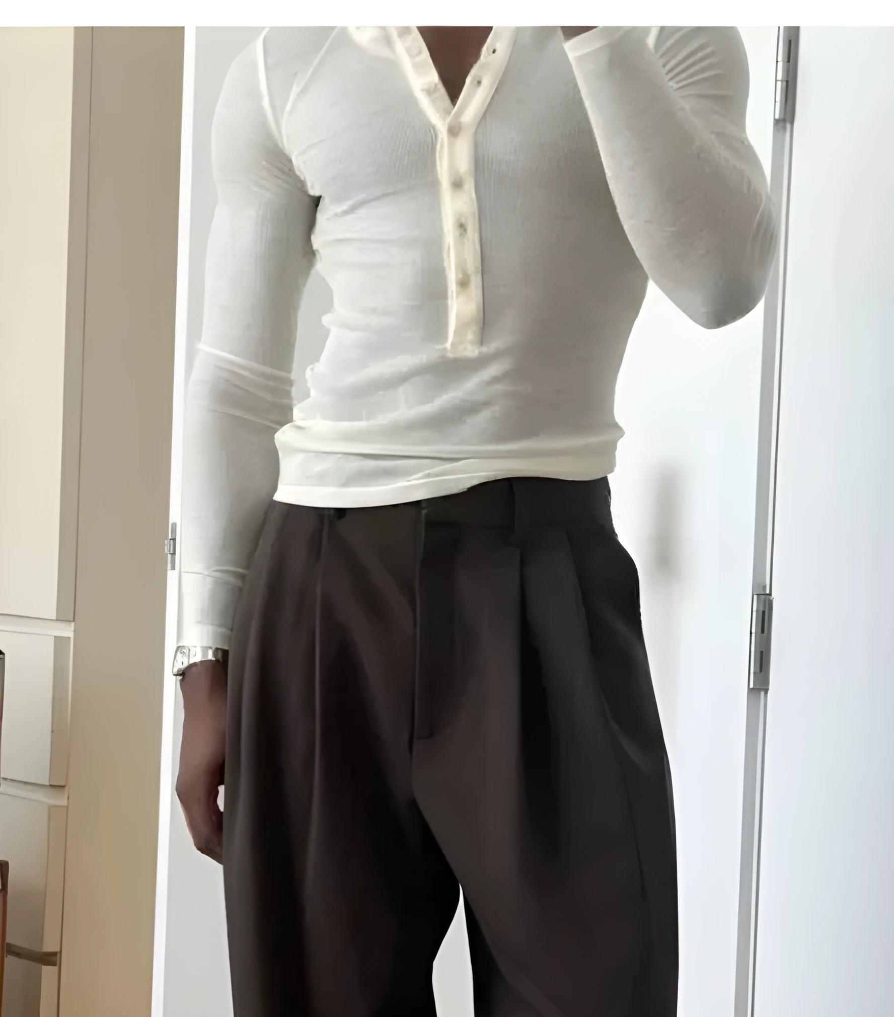 Men's cream apricot coloured ribbed long sleeve henley top with a three-button placket.