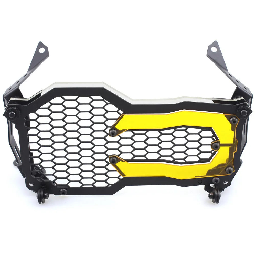 BMW motorcycle headlight protective cover in fluorescent yellow mounted on a GS adventure bike.