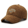 Adjustable lambskin winter baseball cap in black with dome crown and machine embroidery detail.