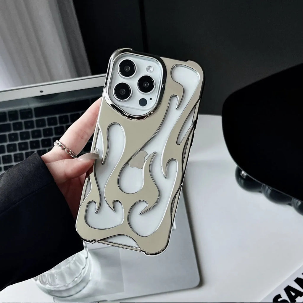 Silver electroplated iPhone case with hollow flame pattern design on a table
