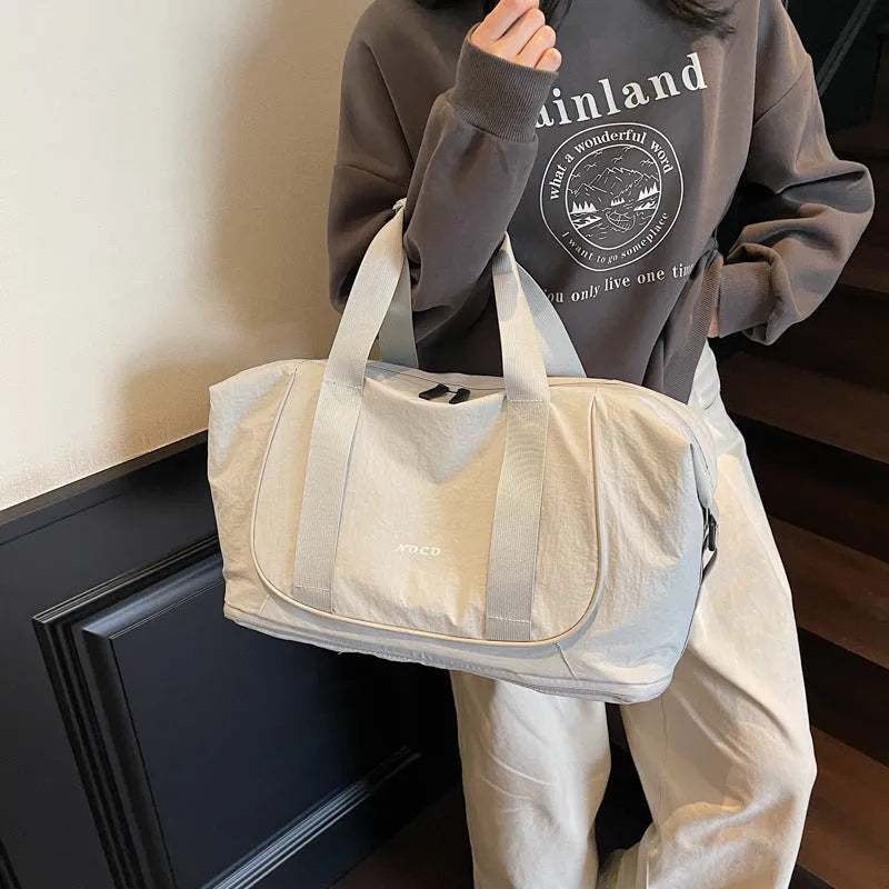 A milky white Oxford cloth crossbody bag for yoga and fitness, shown in a one-shoulder carry style.