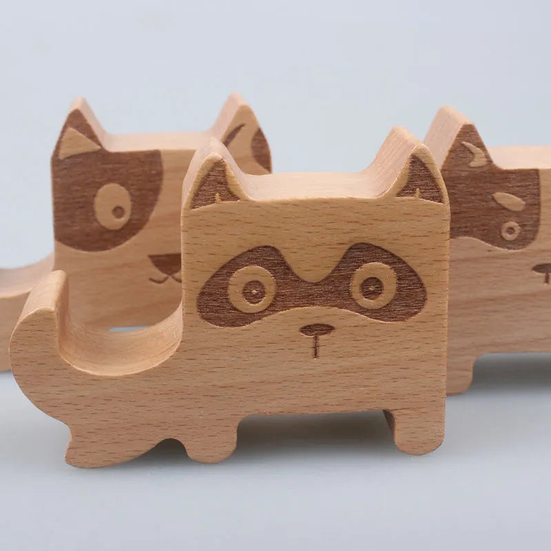 A decorative resin mobile phone stand holding a smartphone, shown in an animal design variant.
