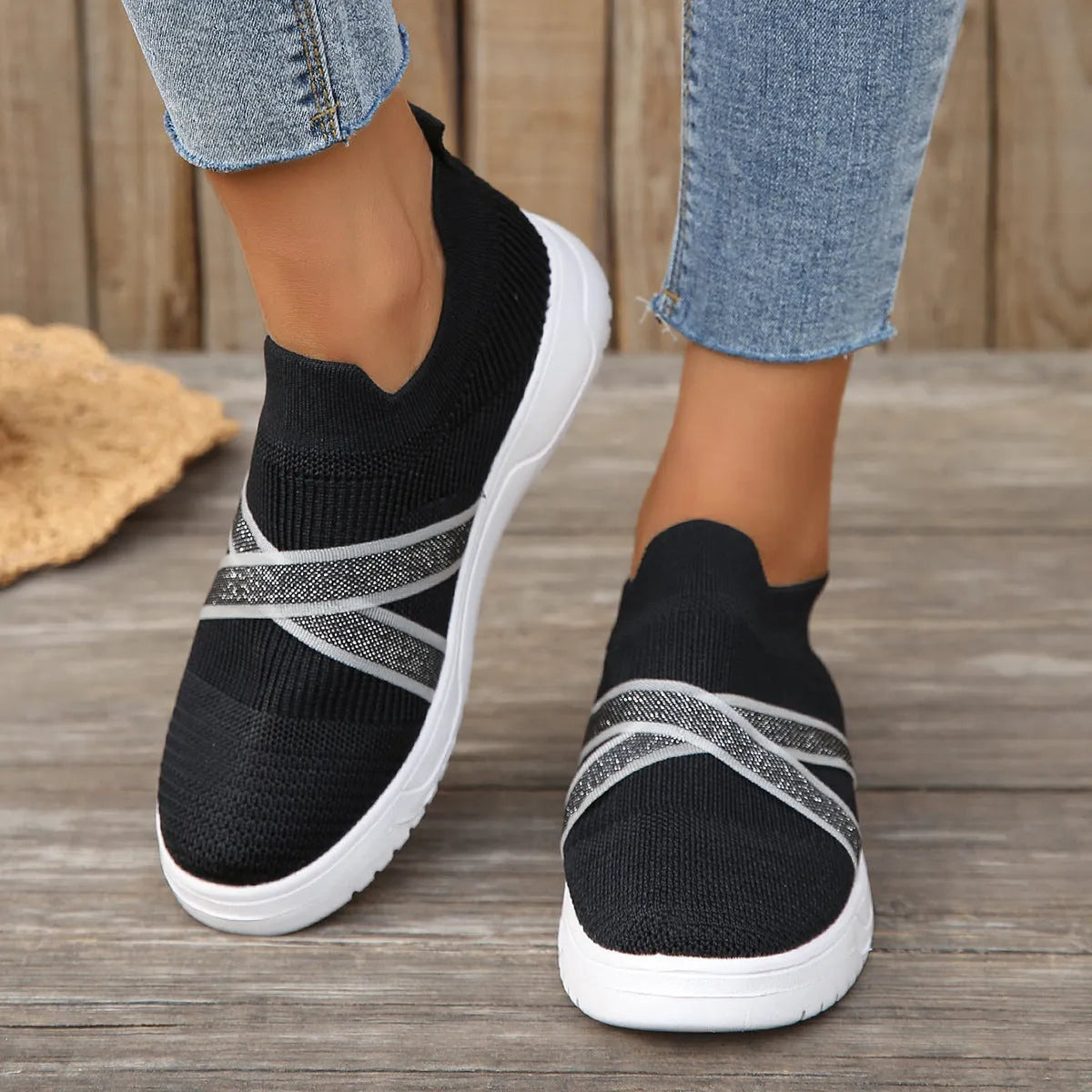 Women's black flyknit mesh outdoor shoes with flat rubber sole and tassel detail.