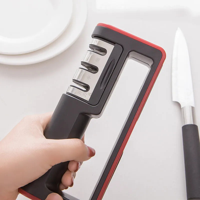 Black and red professional three-stage diamond knife sharpener on a kitchen countertop