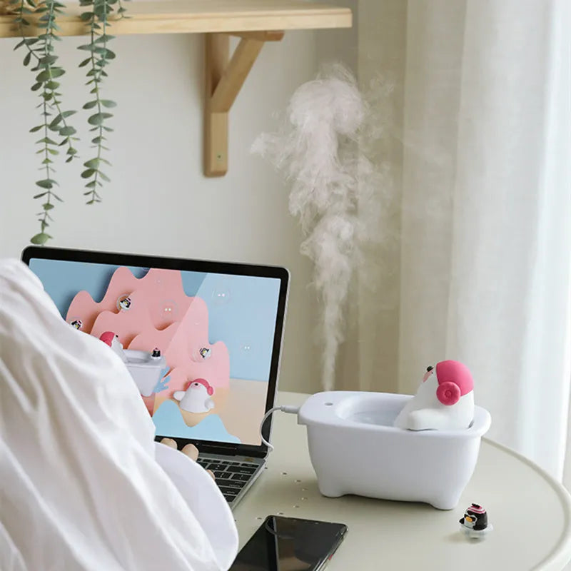 White USB-powered air humidifier and aromatherapy diffuser unit on a desk.