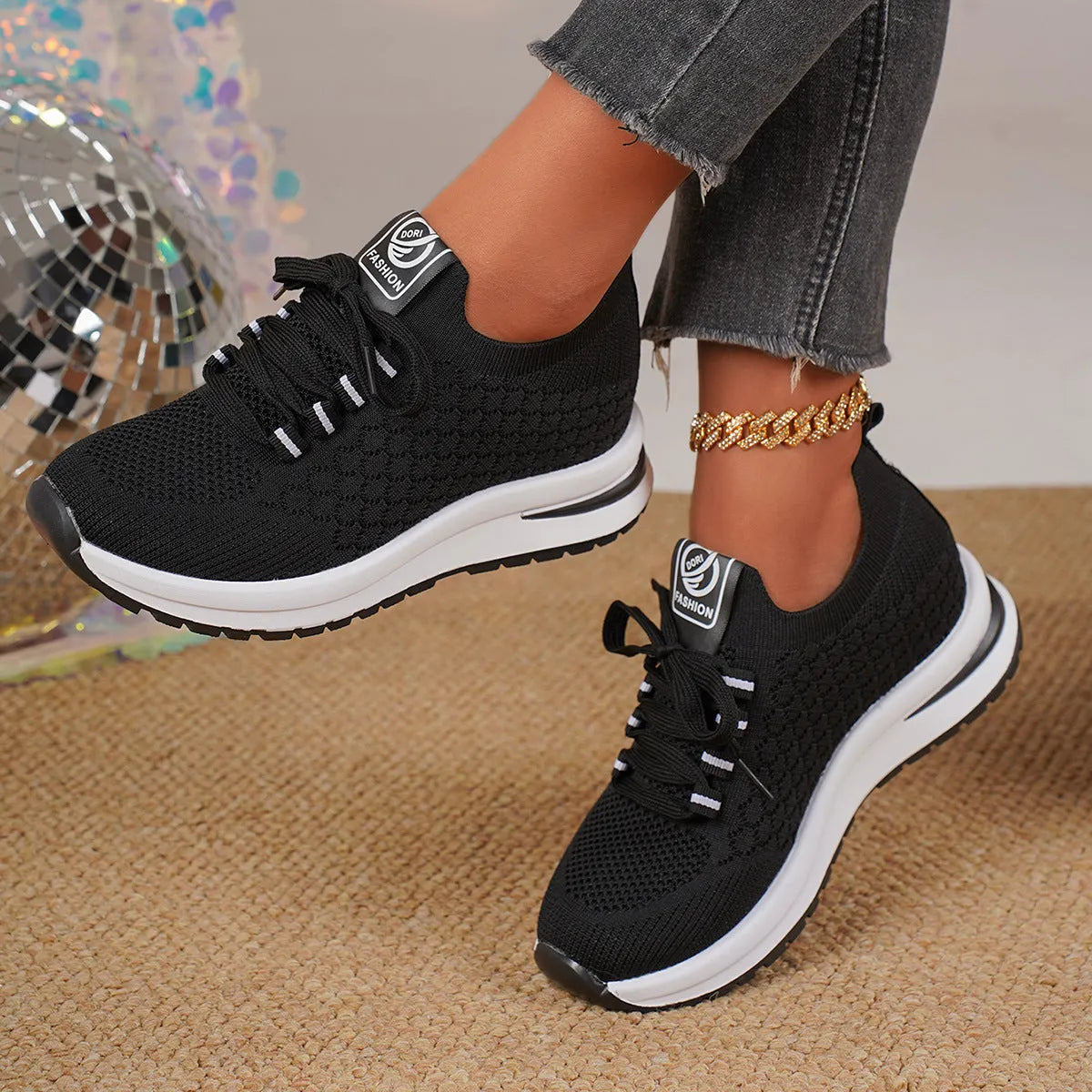 Women's black and white mesh platform sneakers with flat sole and lace-up front.