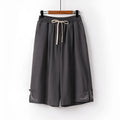 Linen wide leg leisure shorts in apricot colour showing elastic mid waistband and embroidery detail