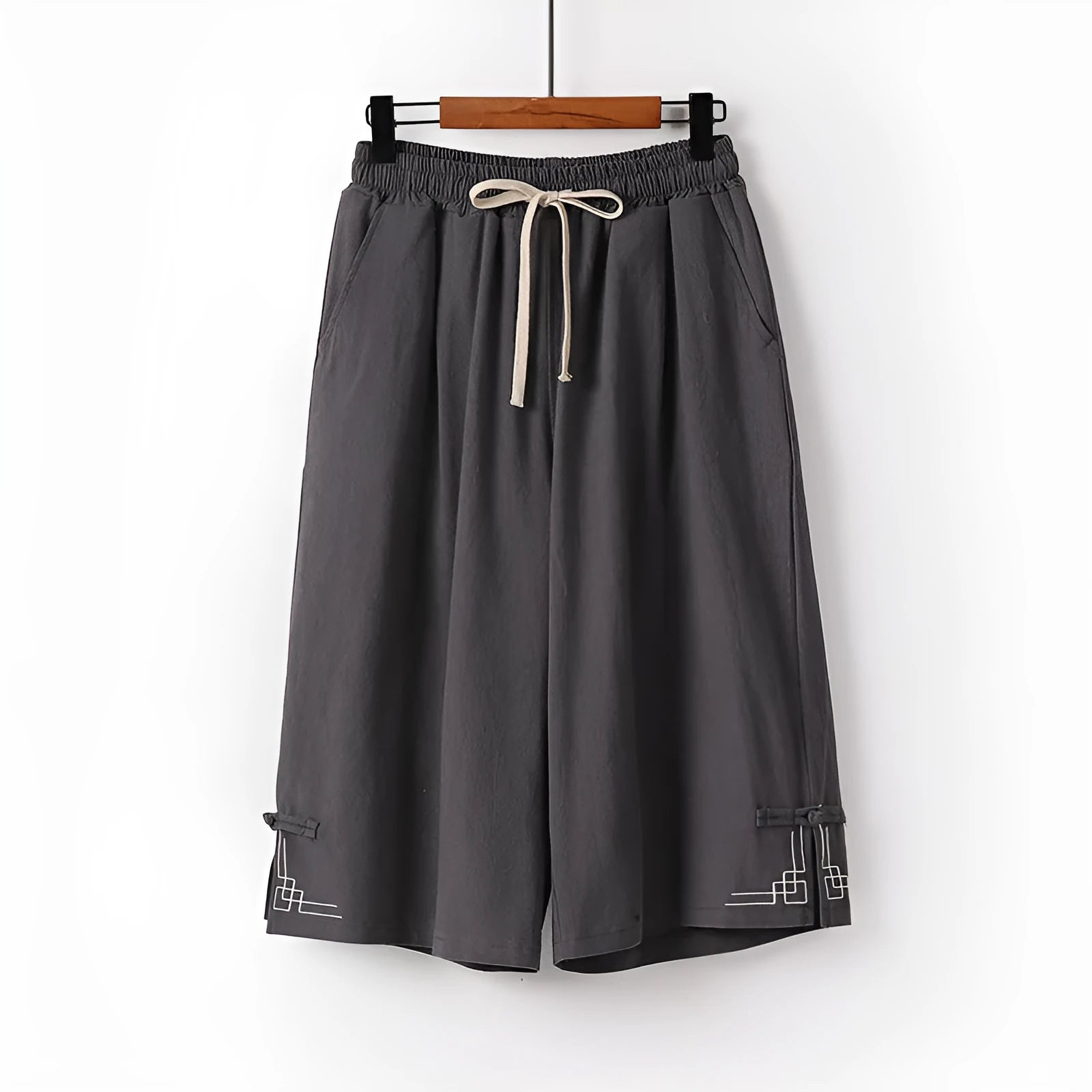 Linen wide leg leisure shorts in apricot colour showing elastic mid waistband and embroidery detail