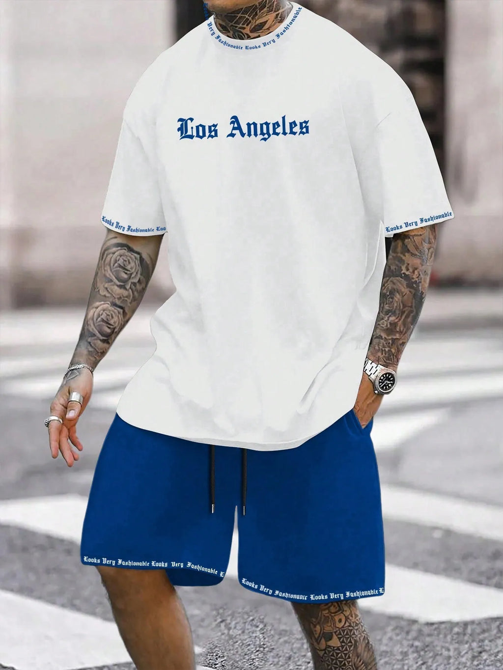 Man wearing a printed short-sleeve top and matching shorts from a sports style suit set.