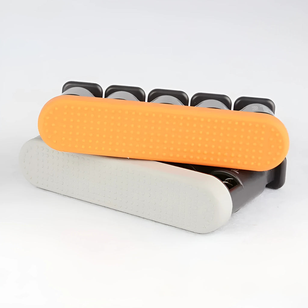 Grey and orange silicone finger trainer for hand strength, used for music practice and climbing.