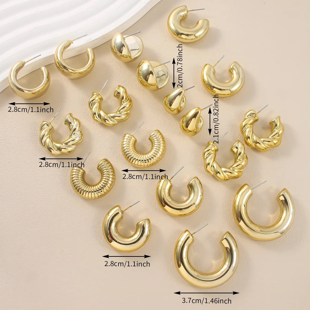 Set of three pairs of acrylic double circle earrings in gold, silver, and black with water drop design