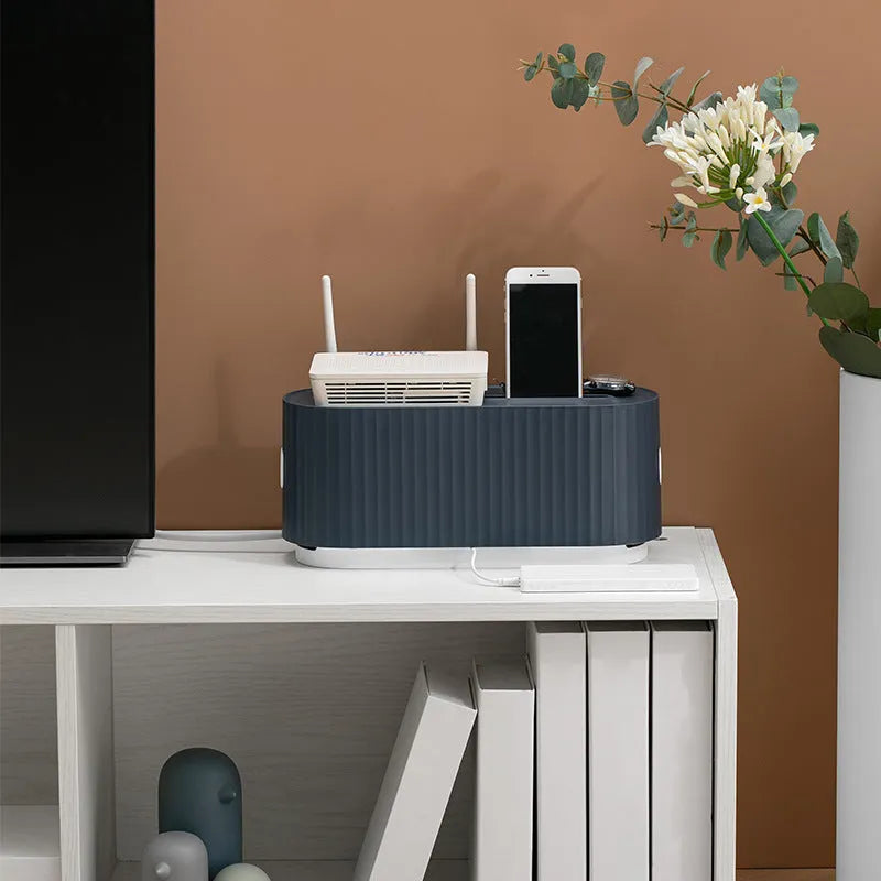 Blue and white power strip storage box with lid open showing cable management holes