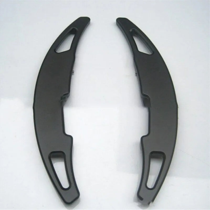Pair of aluminium alloy paddle shift extenders for BMW M models on a black background