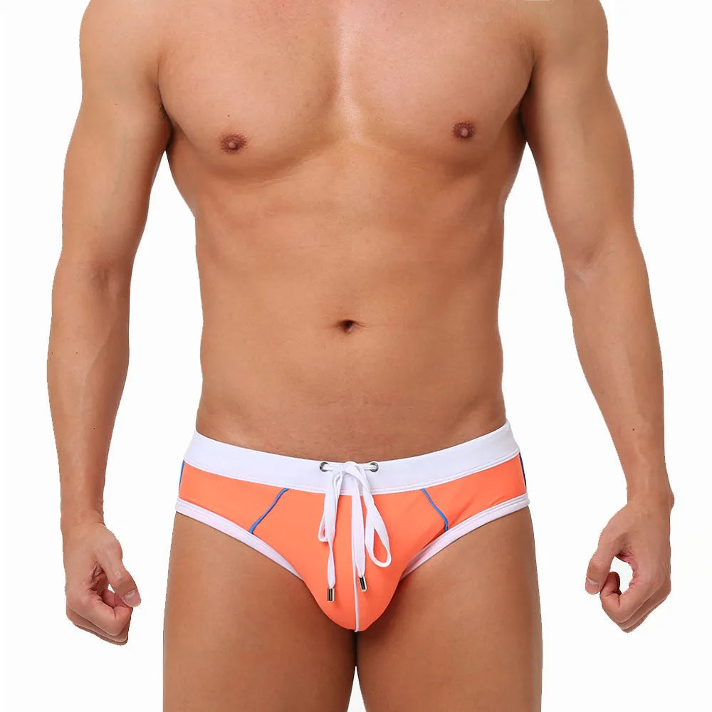Nylon men's swim briefs in orange colour with elastic waistband, front view