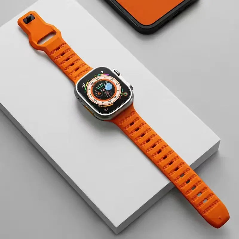 Black fluoro rubber Apple Watch strap with T-buckle on a wrist, showing lightweight design.