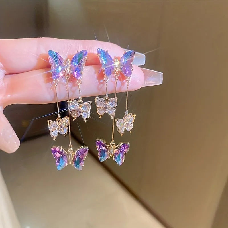 A pair of silver needle-blue purple butterfly tassel earrings with crystal flowers on a 4.5cm drop.