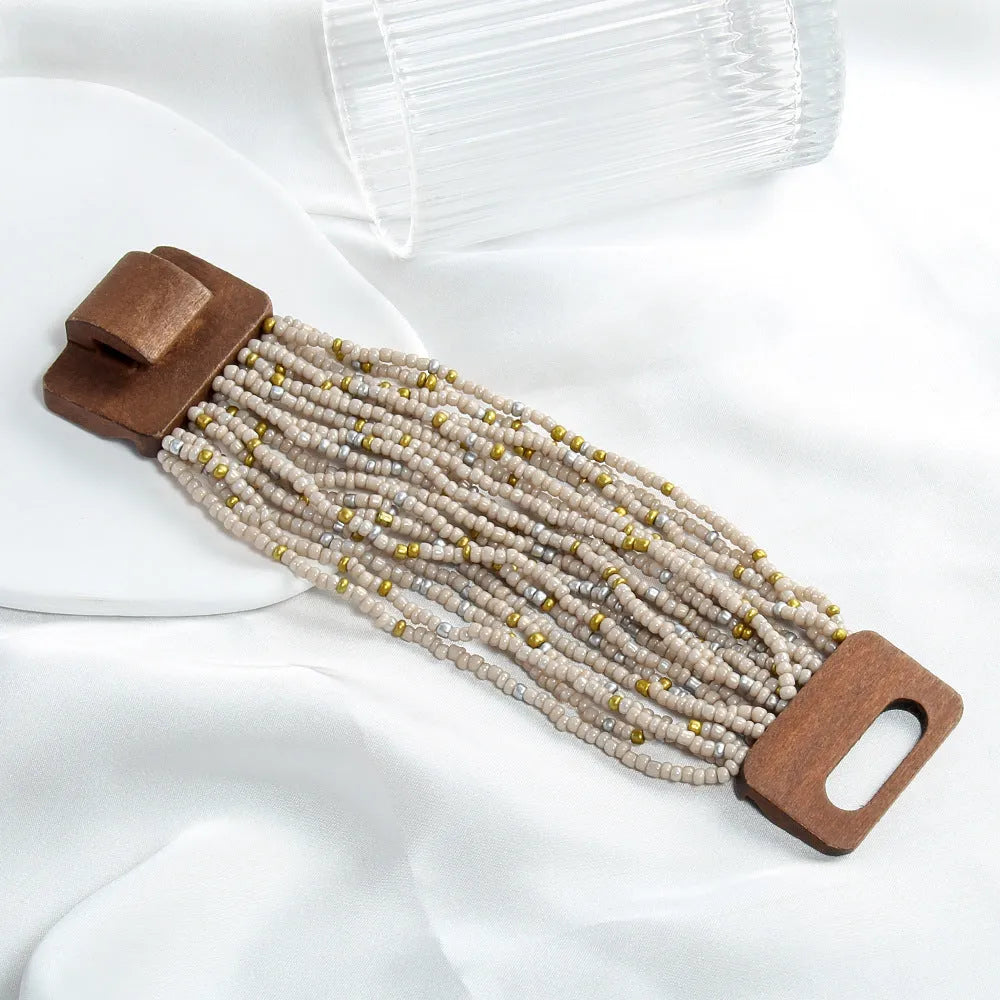 Handmade multi-layer elastic bracelet with rice-shaped glass and coloured glaze beads in geometric quadrilateral pattern, six colour options