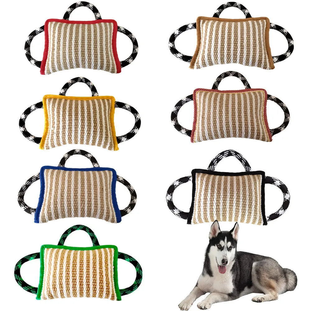 Jute dog tug toy with three rope handles and a central bite pillow, shown in assorted colours.