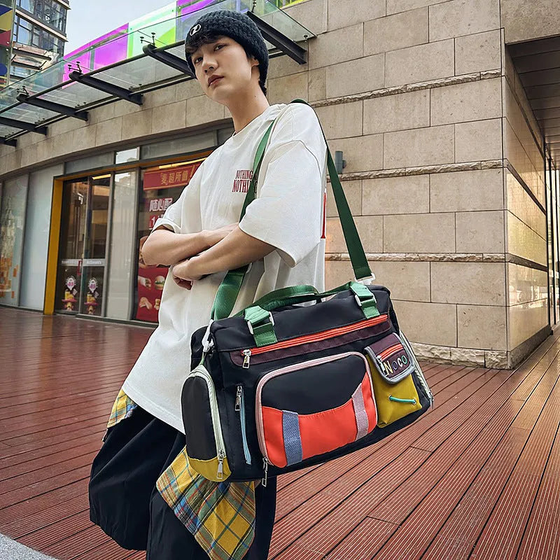 Large black Oxford cloth shoulder messenger bag with a shoulder strap, shown with its dimensions.