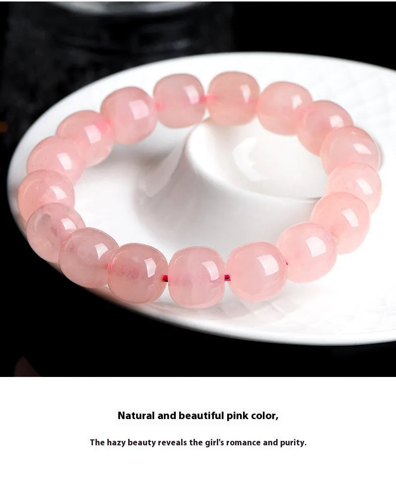 Pink natural crystal barrel bead bracelet with geometric design on wrist