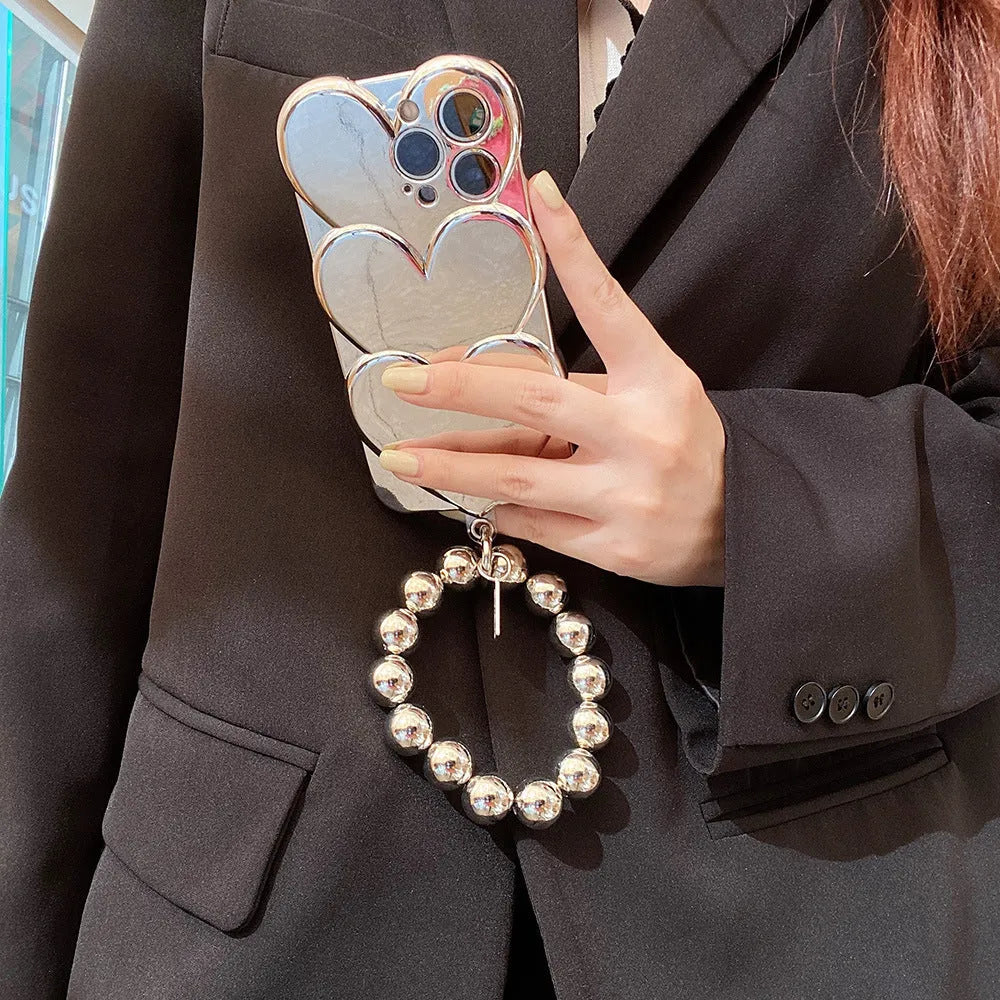Soft TPU iPhone case with shiny 3D electroplating love design, shown next to matching bracelet.